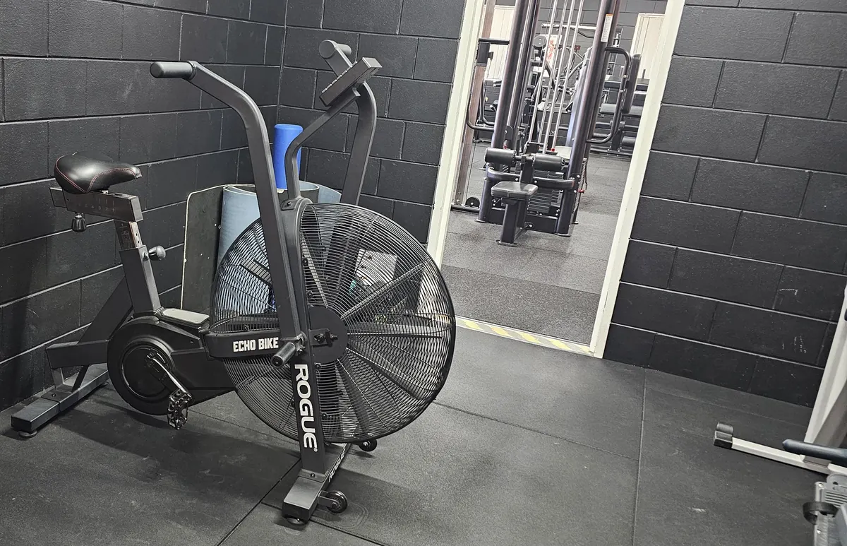 A Rogue Echo air bike against the black brick wall at Get Fit Burdekin