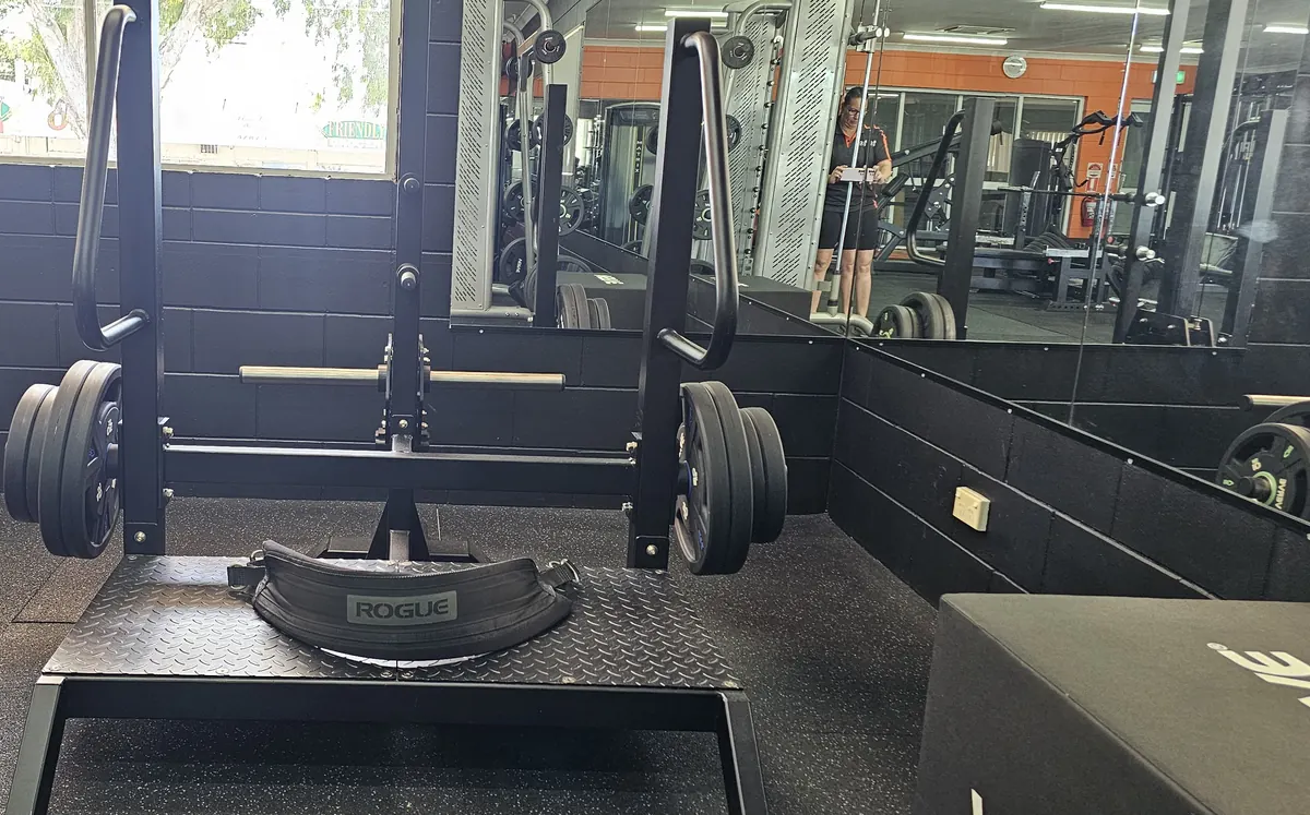 A plate-loaded belt squat with a Rogue belt on its platform at Get Fit Burdekin