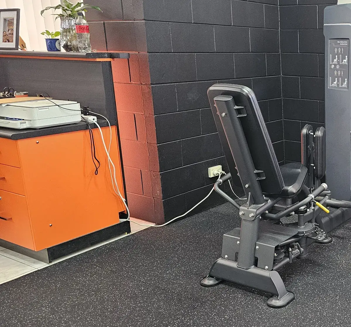 A pin-loaded hip abduction and adduction machine near the front counter at Get Fit Burdekin