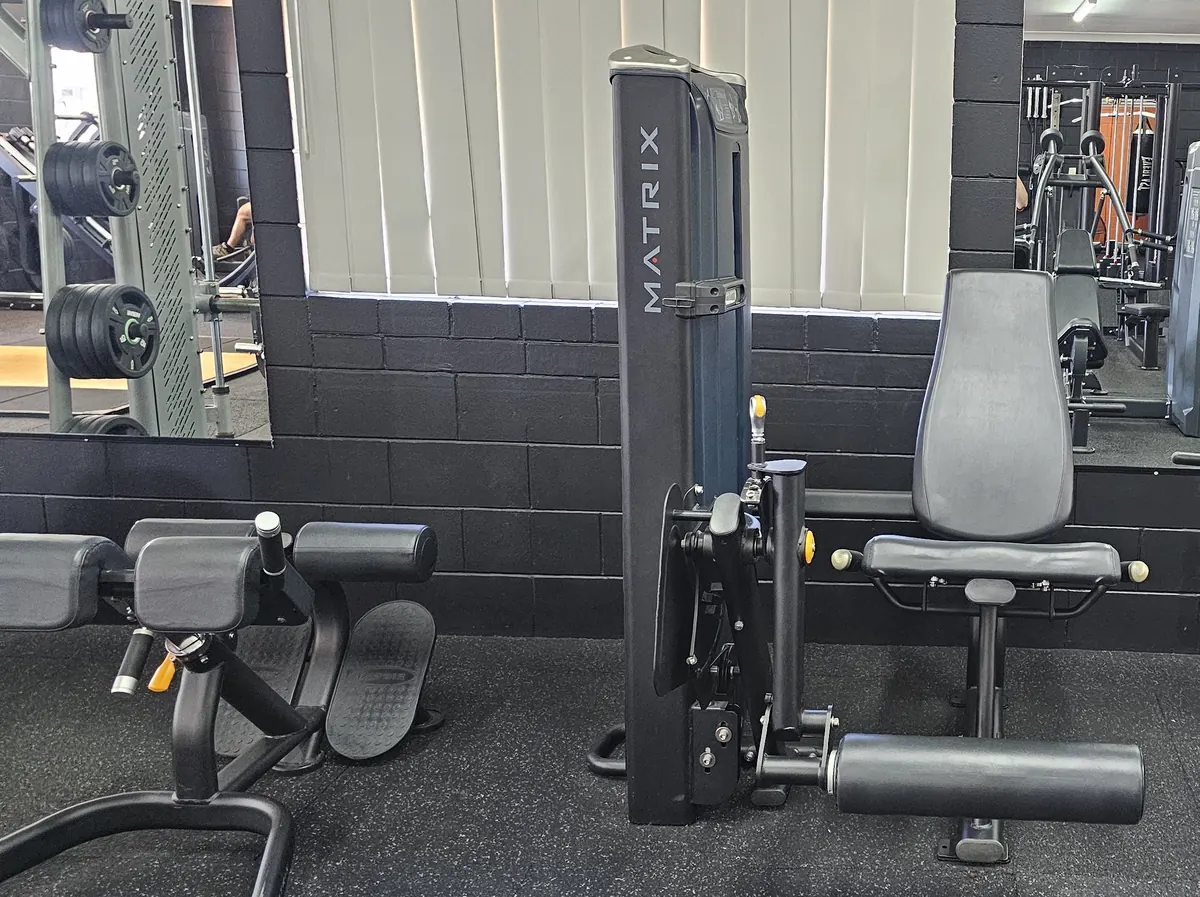 A Matrix pin-loaded seated leg extension in front of the mirrors at Get Fit Burdekin